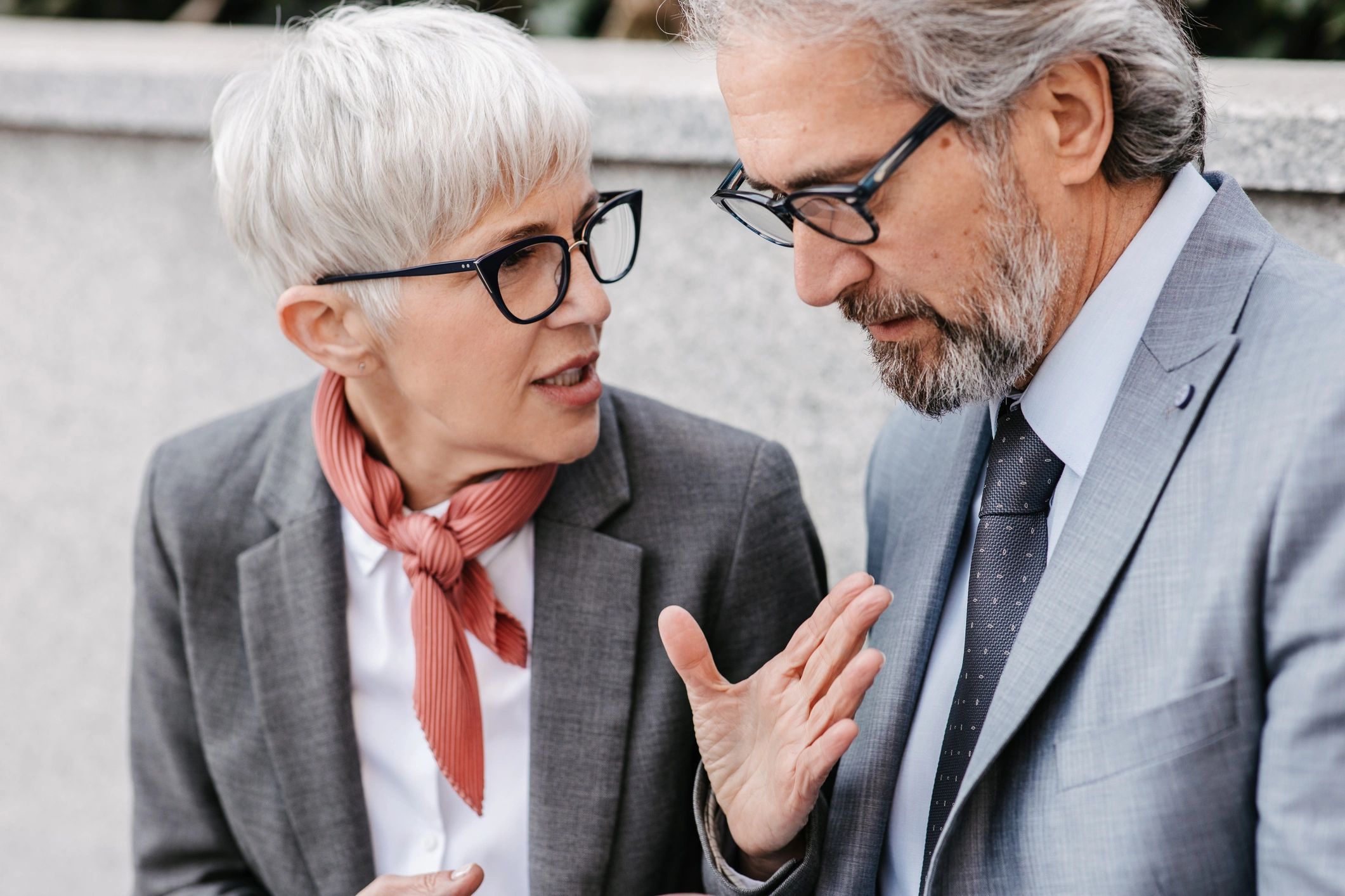 Well-dressed mature couple talking together