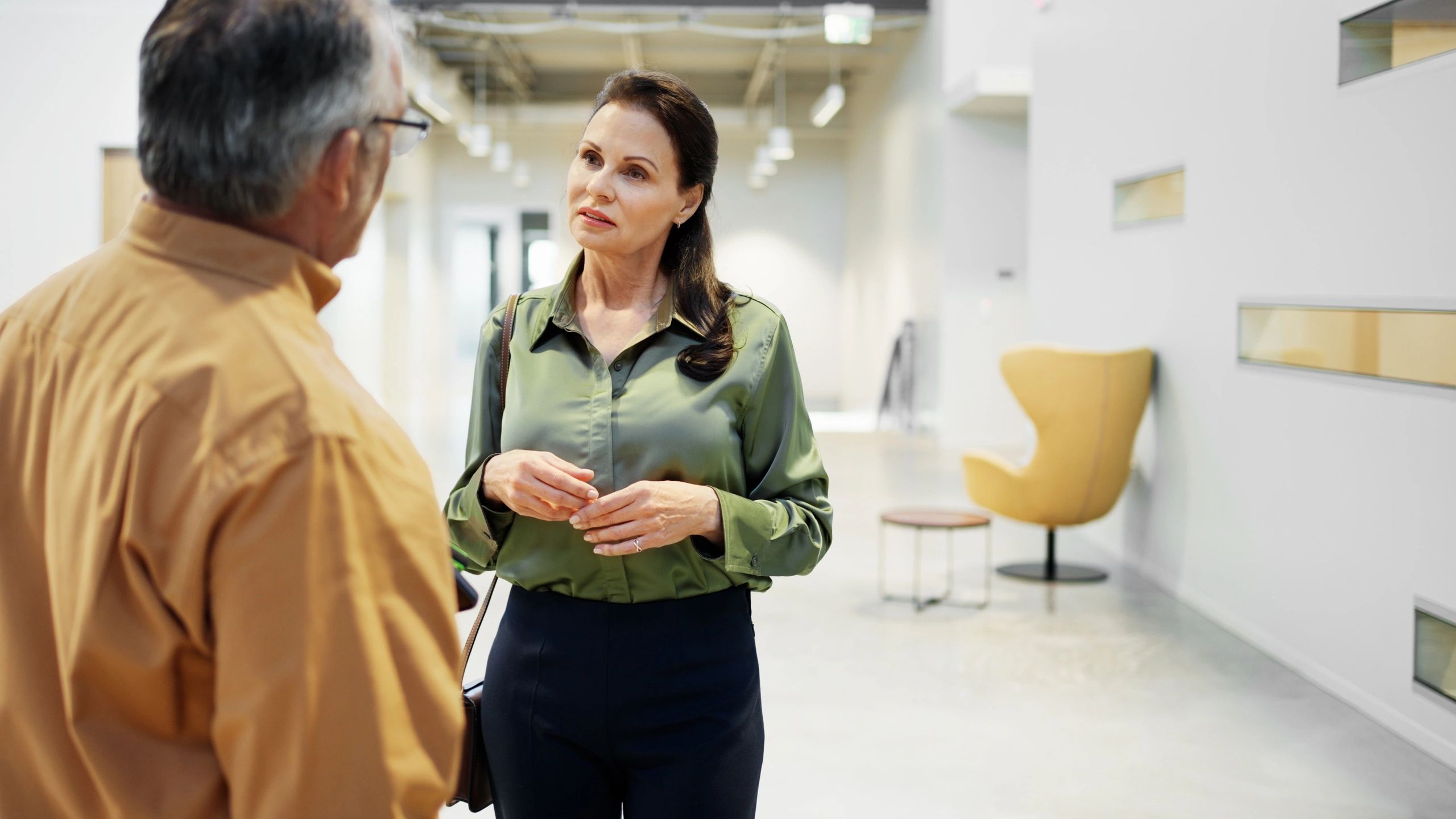 Mature woman and man in conversation during a casual interview setting