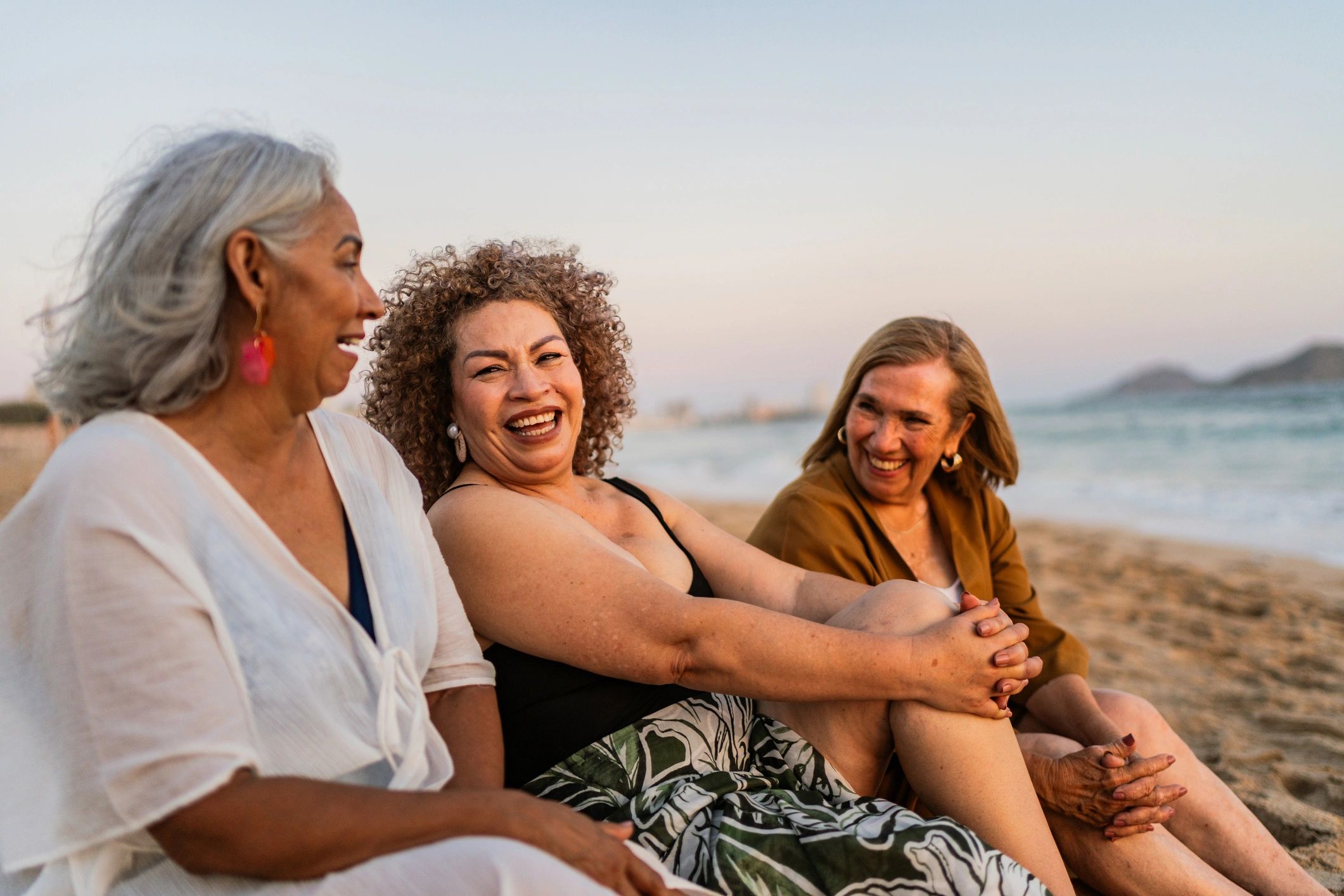 Senior women talking together on the beach