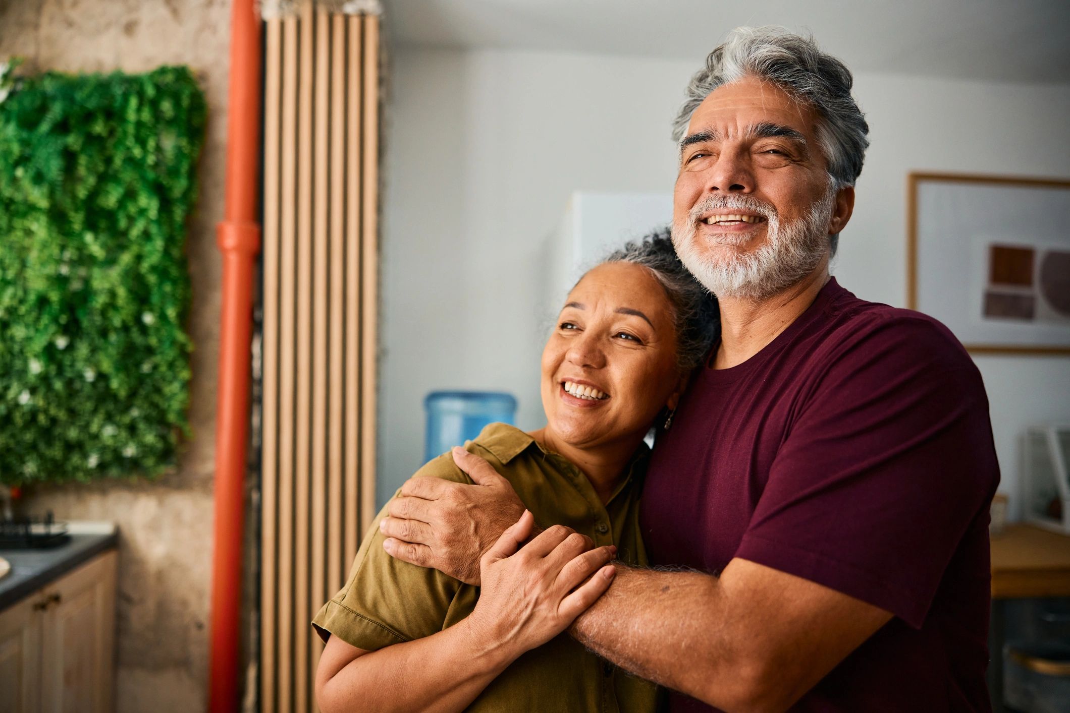 Happy senior couple embracing at home