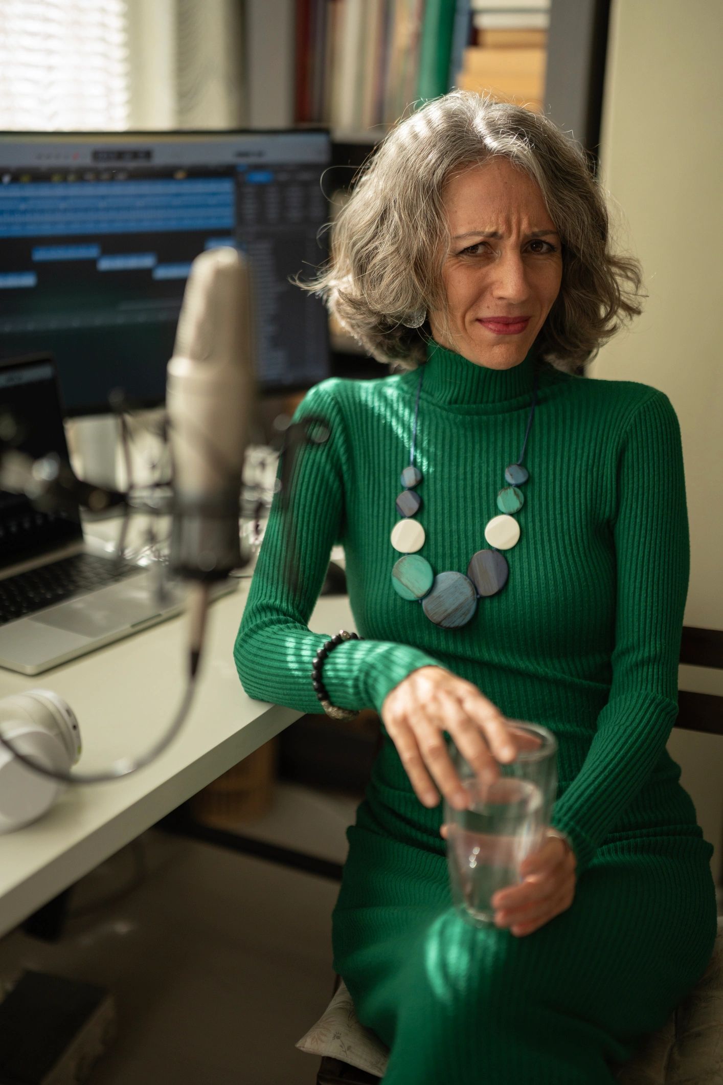 Portrait of a mature woman recording a podcast